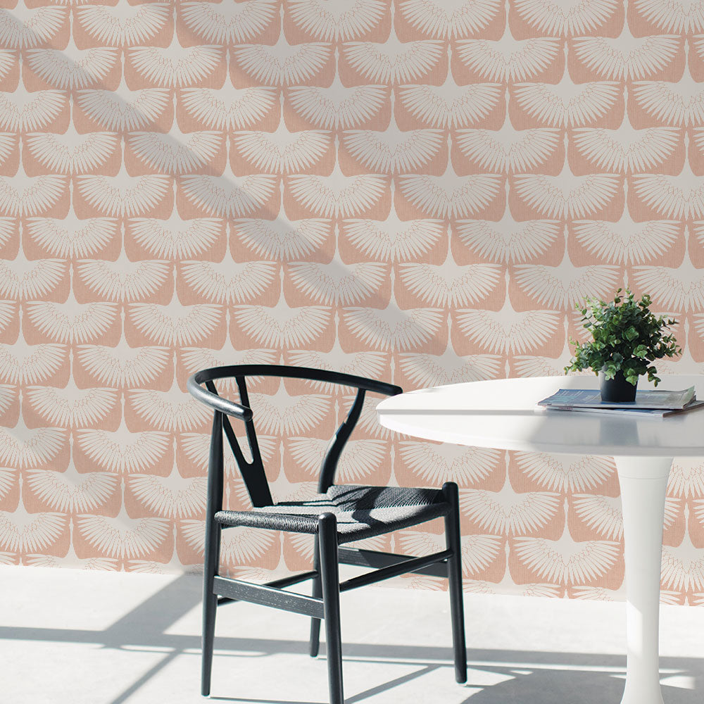 Feather Flock Removable Wallpaper - A white table and black chair in front of a wall featuring Tempaper's Feather Flock Peel And Stick Wallpaper in sahara blush scallops#color_sahara-blush-scallops