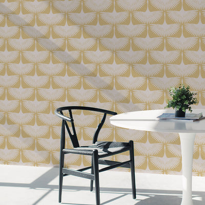 Feather Flock Removable Wallpaper - A white table and black chair in front of a wall featuring Tempaper's Feather Flock Peel And Stick Wallpaper in golden hour scallops#color_golden-hour-scallops