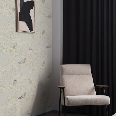 Parliament Non-Pasted Wallpaper - A grey chair and black curtain with Parliament Unpasted Wallpaper in natural beige | Tempaper#color_natural-beige