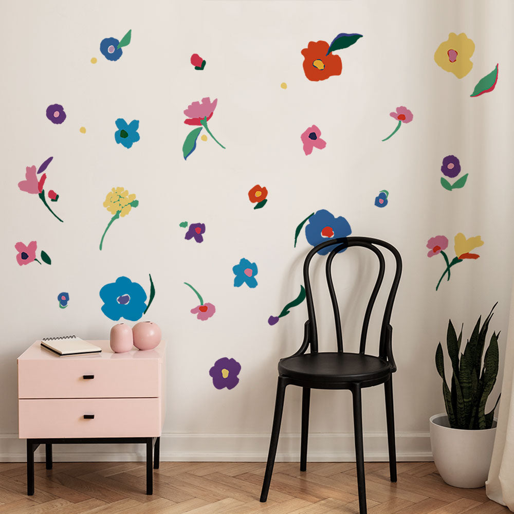 Abstract Flower wall decals features various flowers in bright colors in a kid's room with furniture.