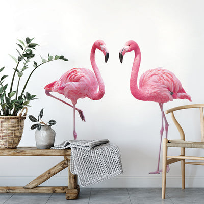 Tempaper's Flamingos Wall Decals shown behind a bench, plants, and a chair.