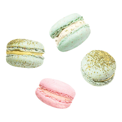 A sample of French Macaron wall decals from Tempaper with four different macaroons: three light green with gold sprinkles and one pink.