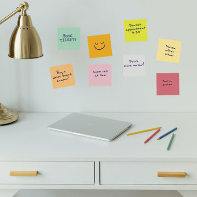 Tempaper's Dry Erase Sticky Notes Wall Decals shown above a desk behind a lamp.