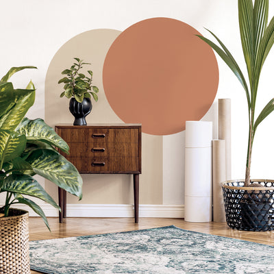 Tempaper's Circle Wall Decal shown behind plants and a desk.