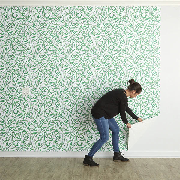 Image of person removing Tempaper peel and stick wallpaper cleanly