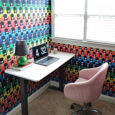  White desk with laptop in front of Tempaper's Rainbow Stace Peel And Stick Wallpaper By Alice + Olivia.
