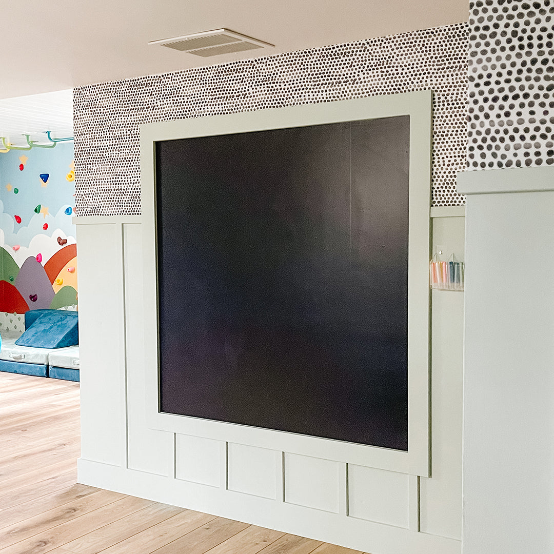 A framed out space for chalkboard wallpaper in a kids playroom