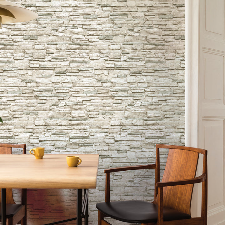 Light Stone Removable Wallpaper - A wood table and two wood chairs in a room featuring Tempaper's Light Stone Peel And Stick Wallpaper | Tempaper