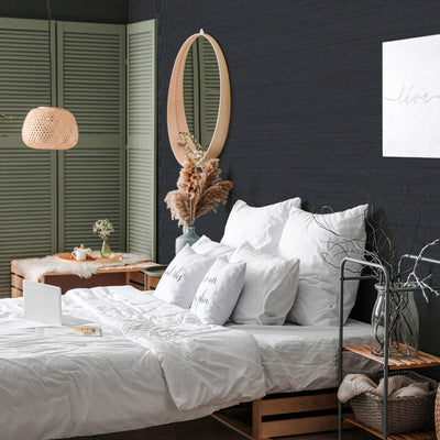 Faux Horizontal Grasscloth Removable Wallpaper - A bedroom with a bed and wood furniture featuring Faux Horizontal Grasscloth Peel And Stick Wallpaper in textured navy | Tempaper#color_textured-navy