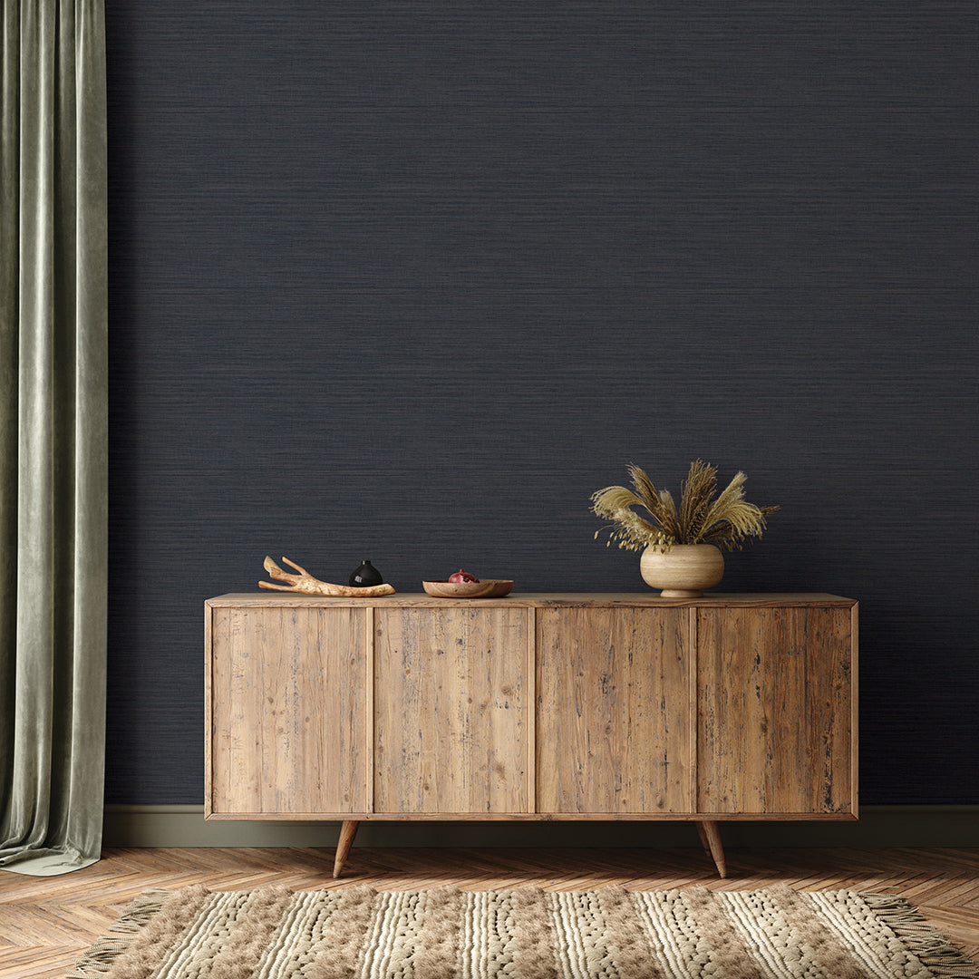 Faux Horizontal Grasscloth Removable Wallpaper - A wood sideboard and a rug in a room featuring Faux Horizontal Grasscloth Peel And Stick Wallpaper in textured navy | Tempaper#color_textured-navy