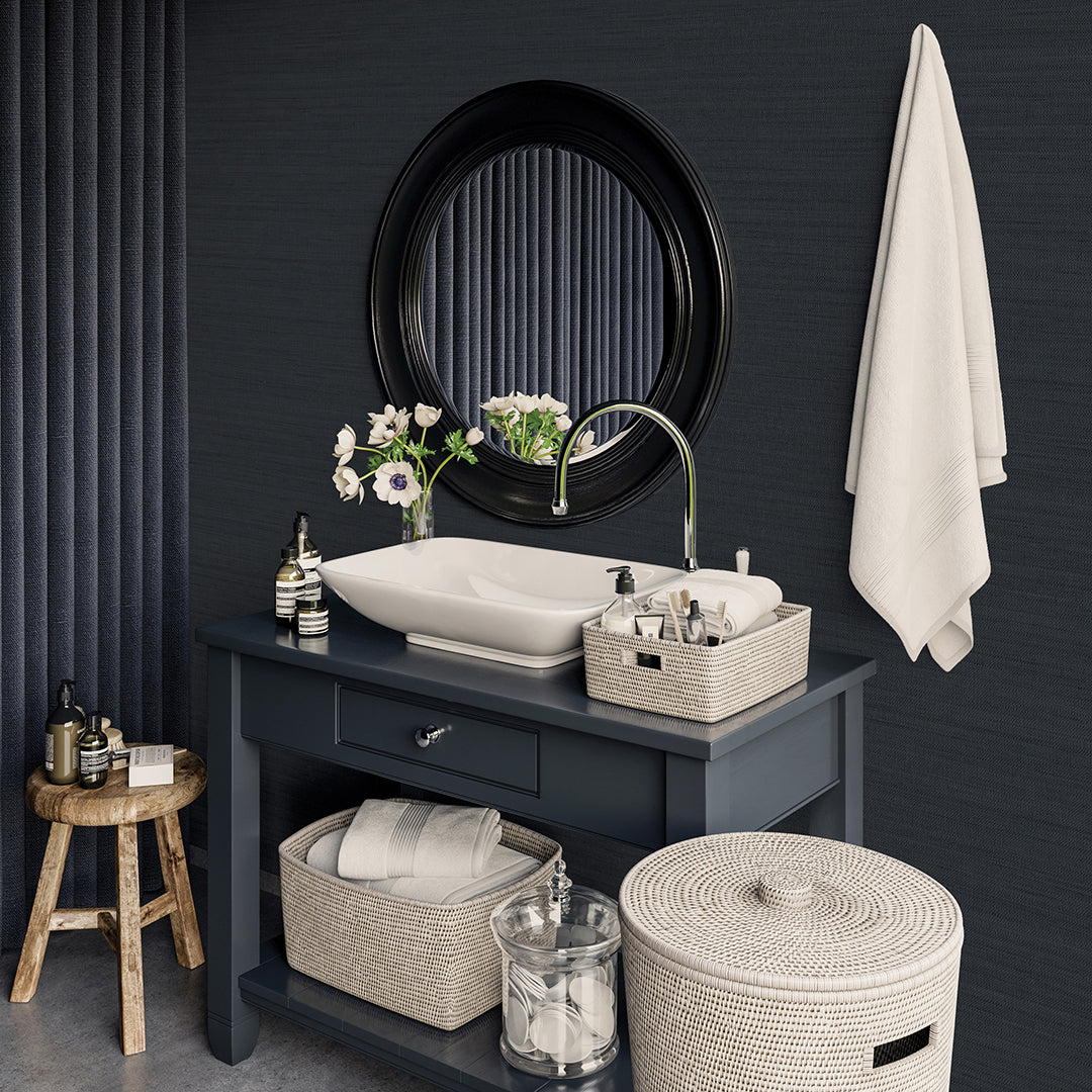 Faux Horizontal Grasscloth Removable Wallpaper - A bathroom with a dark gray vanity and white sink underneath a black mirror, featuring Faux Horizontal Grasscloth Peel And Stick Wallpaper in textured navy | Tempaper#color_textured-navy