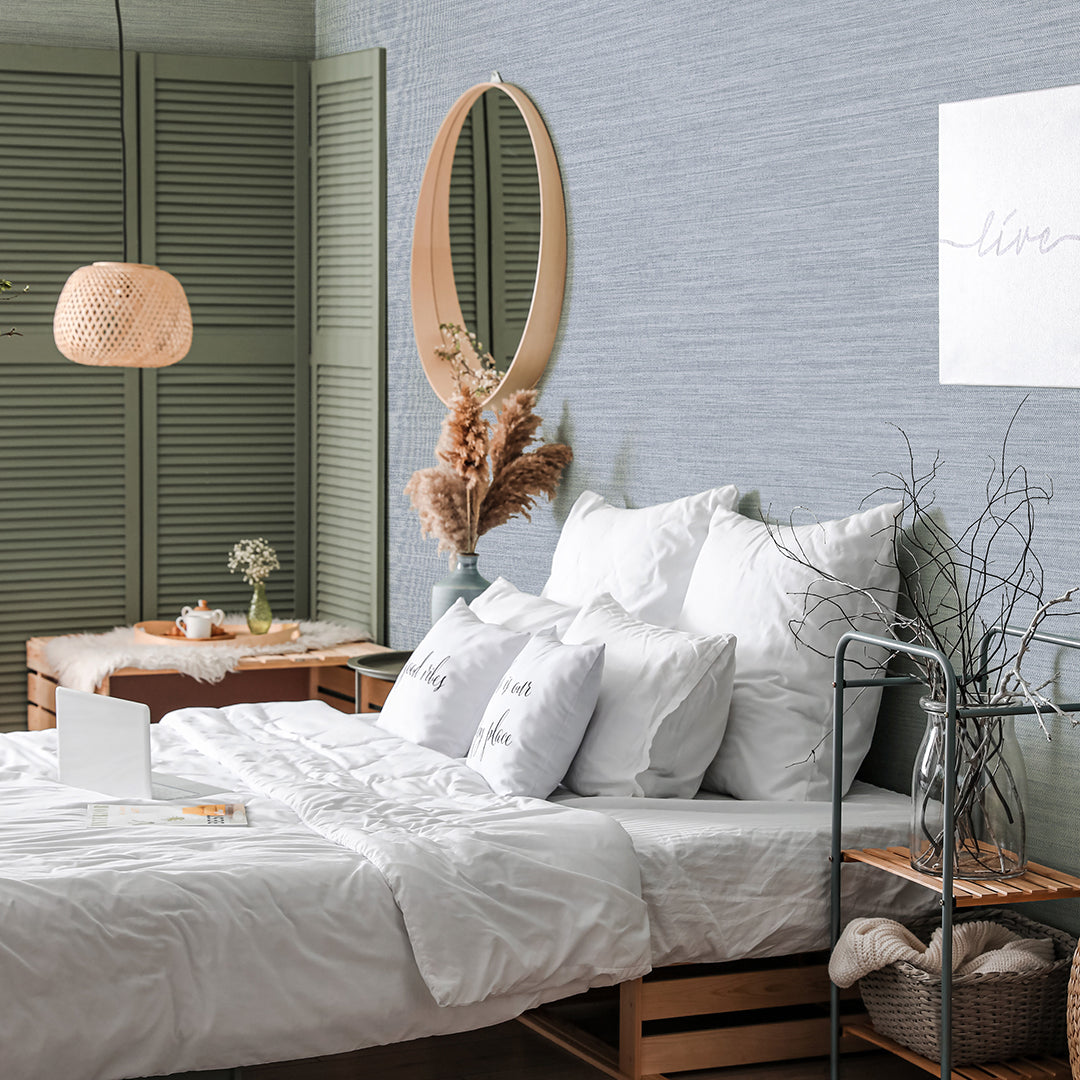 Faux Horizontal Grasscloth Removable Wallpaper - A bedroom with a bed and wood furniture featuring Faux Horizontal Grasscloth Peel And Stick Wallpaper in textured powder blue | Tempaper#color_textured-powder-blue