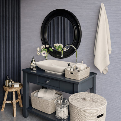 Faux Horizontal Grasscloth Removable Wallpaper - A bathroom with a dark gray vanity and white sink underneath a black mirror, featuring Faux Horizontal Grasscloth Peel And Stick Wallpaper in textured powder blue | Tempaper#color_textured-powder-blue