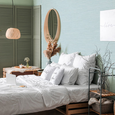 Faux Horizontal Grasscloth Removable Wallpaper - A bedroom with a bed and wood furniture featuring Faux Horizontal Grasscloth Peel And Stick Wallpaper in textured seaglass | Tempaper#color_textured-seaglass