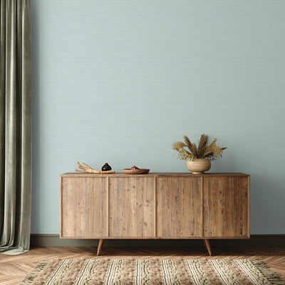 Faux Horizontal Grasscloth Removable Wallpaper - A wood sideboard and a rug in a room featuring Faux Horizontal Grasscloth Peel And Stick Wallpaper in textured seaglass | Tempaper#color_textured-seaglass