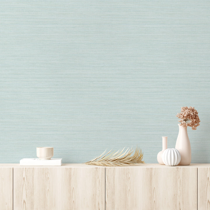 Faux Horizontal Grasscloth Removable Wallpaper - A wood dresser with beige vases and a wall featuring Faux Horizontal Grasscloth Peel And Stick Wallpaper in textured seaglass | Tempaper#color_textured-seaglass