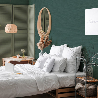 Faux Horizontal Grasscloth Removable Wallpaper - A bedroom with a bed and wood furniture featuring Faux Horizontal Grasscloth Peel And Stick Wallpaper in textured mediterranean teal | Tempaper#color_textured-mediterranean-teal