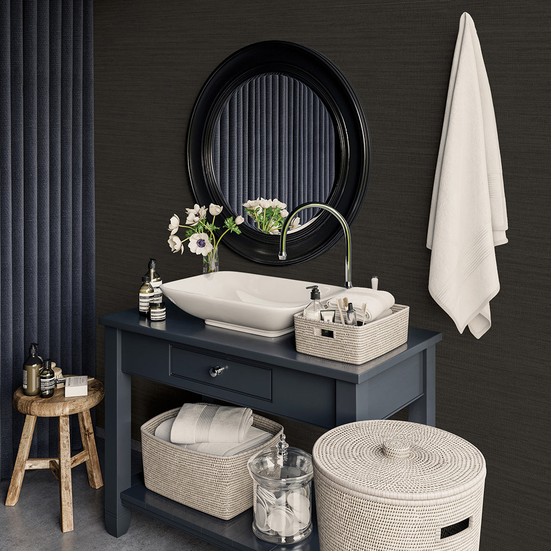 Faux Horizontal Grasscloth Removable Wallpaper - A bathroom with a dark gray vanity and white sink underneath a black mirror, featuring Faux Horizontal Grasscloth Peel And Stick Wallpaper in textured black raven | Tempaper#color_textured-black-raven