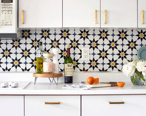 Image of Soleil wallpaper print being used as a backsplash in a kitchen with white cabinets