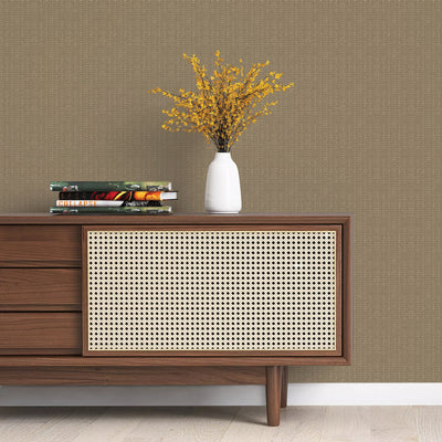 Batik Stripe Removable Wallpaper - A wood sideboard with books and a white vase on top in a room featuring Batik Stripe Peel And Stick Wallpaper in macadamia | Tempaper#color_macadamia