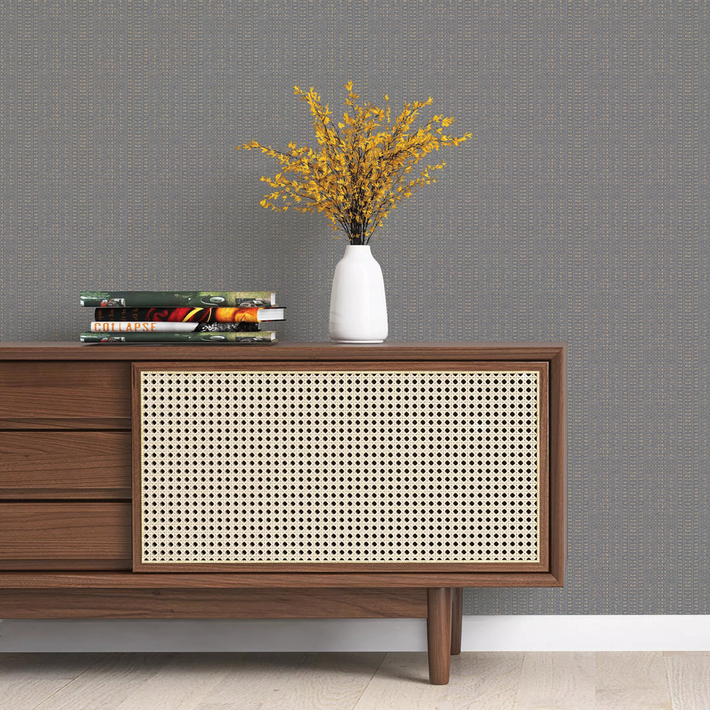 Batik Stripe Removable Wallpaper - A wood sideboard with books and a white vase on top in a room featuring Batik Stripe Peel And Stick Wallpaper in denim | Tempaper#color_denim