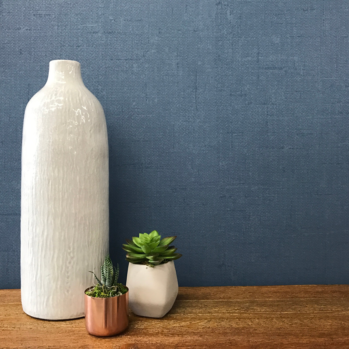 Burlap Removable Wallpaper - A wood shelf with a white vase and two plants in a room featuring Burlap Peel And Stick Wallpaper in navy burlap | Tempaper#color_navy-burlap