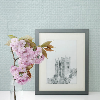 Burlap Removable Wallpaper - A clear vase with pink flowers and a picture in front of a wall featuring Burlap Peel And Stick Wallpaper in ocean mist burlap | Tempaper#color_ocean-mist-burlap