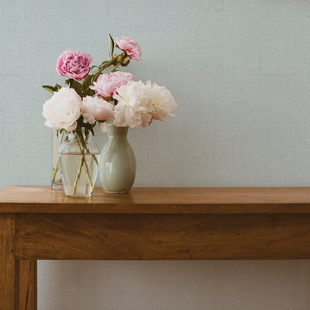 Burlap Removable Wallpaper - A wood bench with vases filled with flowers in a room featuring Burlap Peel And Stick Wallpaper in ocean mist burlap | Tempaper#color_ocean-mist-burlap