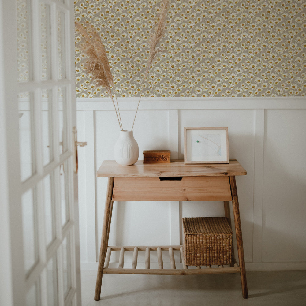 Daisies Removable Wallpaper - A wood desk with a white vase and picture on top underneath a wall featuring Tempaper's Daisies Peel And Stick Wallpaper By Novogratz | Tempaper