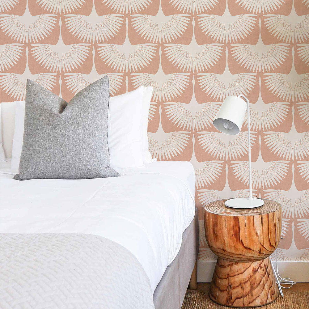 Feather Flock Removable Wallpaper - A bed, wood nightstand, and a white lamp in a bedroom featuring Tempaper's Feather Flock Peel And Stick Wallpaper in sahara blush scallops#color_sahara-blush-scallops