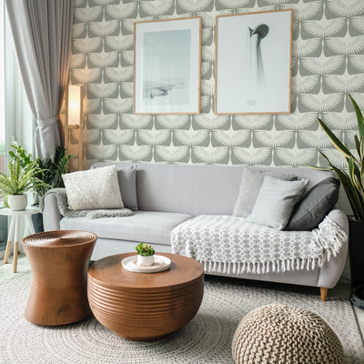 Feather Flock Removable Wallpaper - A grey couch, brown coffee tables, and plants in a room featuring Tempaper's Feather Flock Peel And Stick Wallpaper in chalk scallops#color_chalk-scallops