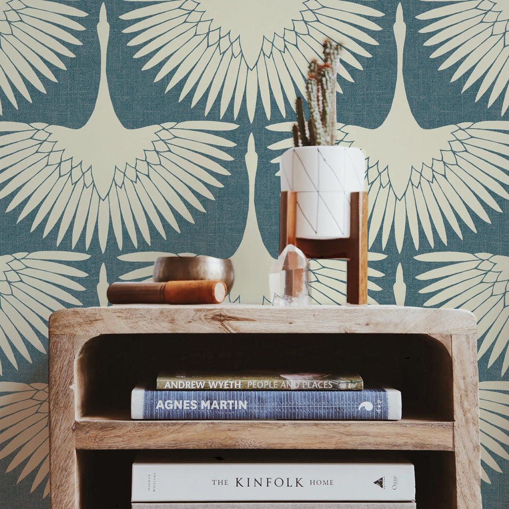 Feather Flock Removable Wallpaper - A wood bookcase in front of a wall featuring Tempaper's Feather Flock Peel And Stick Wallpaper in denim blue scallops#color_denim-blue-scallops