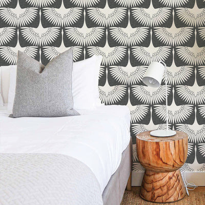 Feather Flock Removable Wallpaper - A bed, wood nightstand, and a white lamp in a bedroom featuring Tempaper's Feather Flock Peel And Stick Wallpaper in storm grey scallops#color_storm-grey-scallops