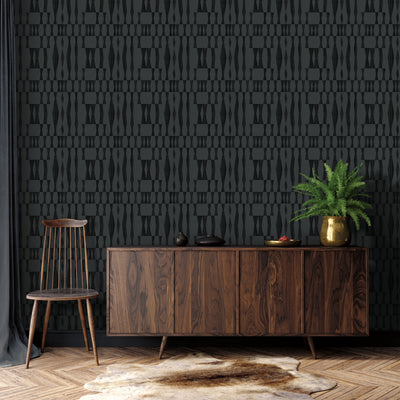 Faux Grasscloth Geo Removable Wallpaper - A wood sideboard and wood chair in front of a wall featuring Faux Grasscloth Geo Peel And Stick Wallpaper in textured carbon | Tempaper#color_textured-carbon