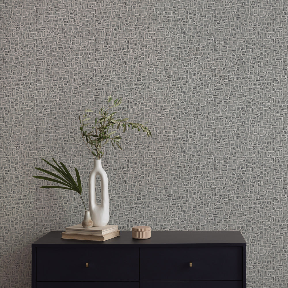 Glyph Geo Non-Pasted Wallpaper - A black dresser with plants in white vases in front of Glyph Geo Unpasted Wallpaper in graphite geo | Tempaper#color_graphite-geo