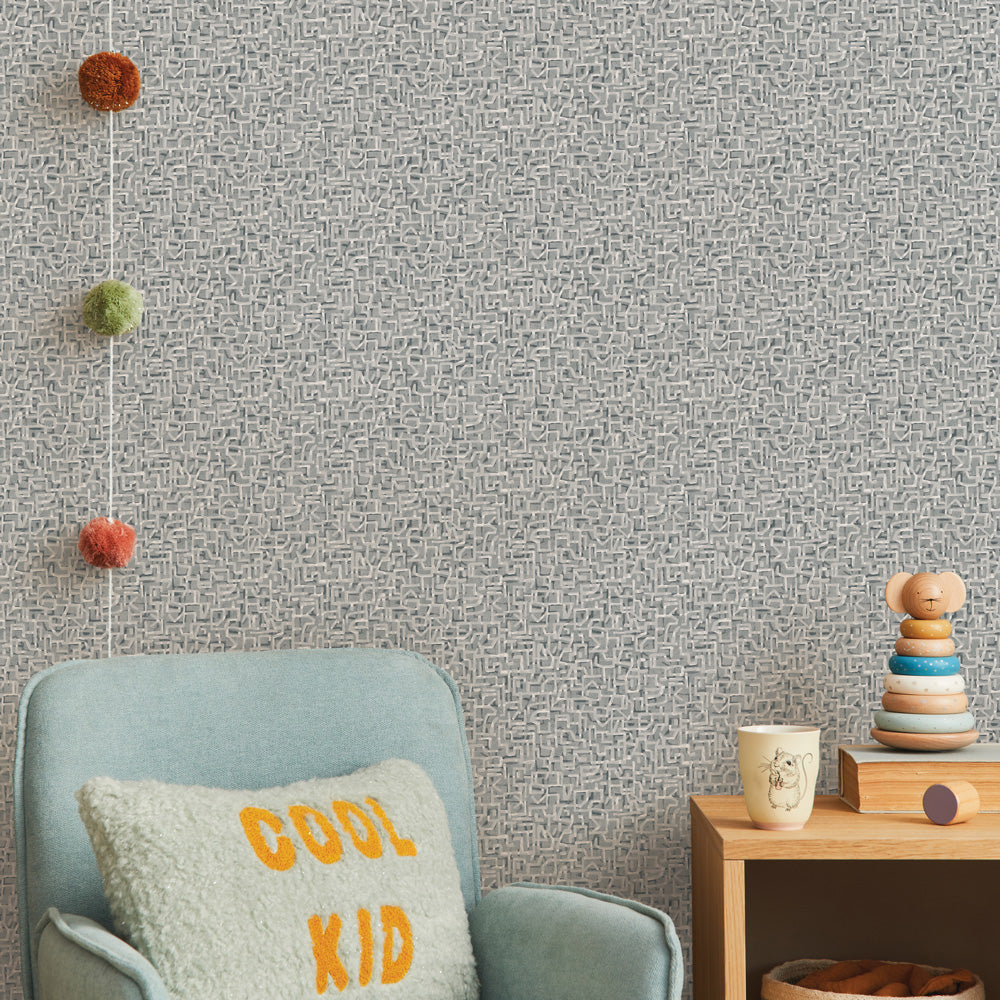Glyph Geo Non-Pasted Wallpaper - A kids bedroom with a blue chair and wood dresser featuring Glyph Geo Unpasted Wallpaper in graphite  geo | Tempaper#color_graphite-geo