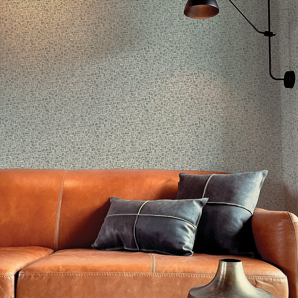 Glyph Geo Non-Pasted Wallpaper - A brown leather couch with black pillows in front of Glyph Geo Unpasted Wallpaper in graphite geo | Tempaper#color_graphite-geo