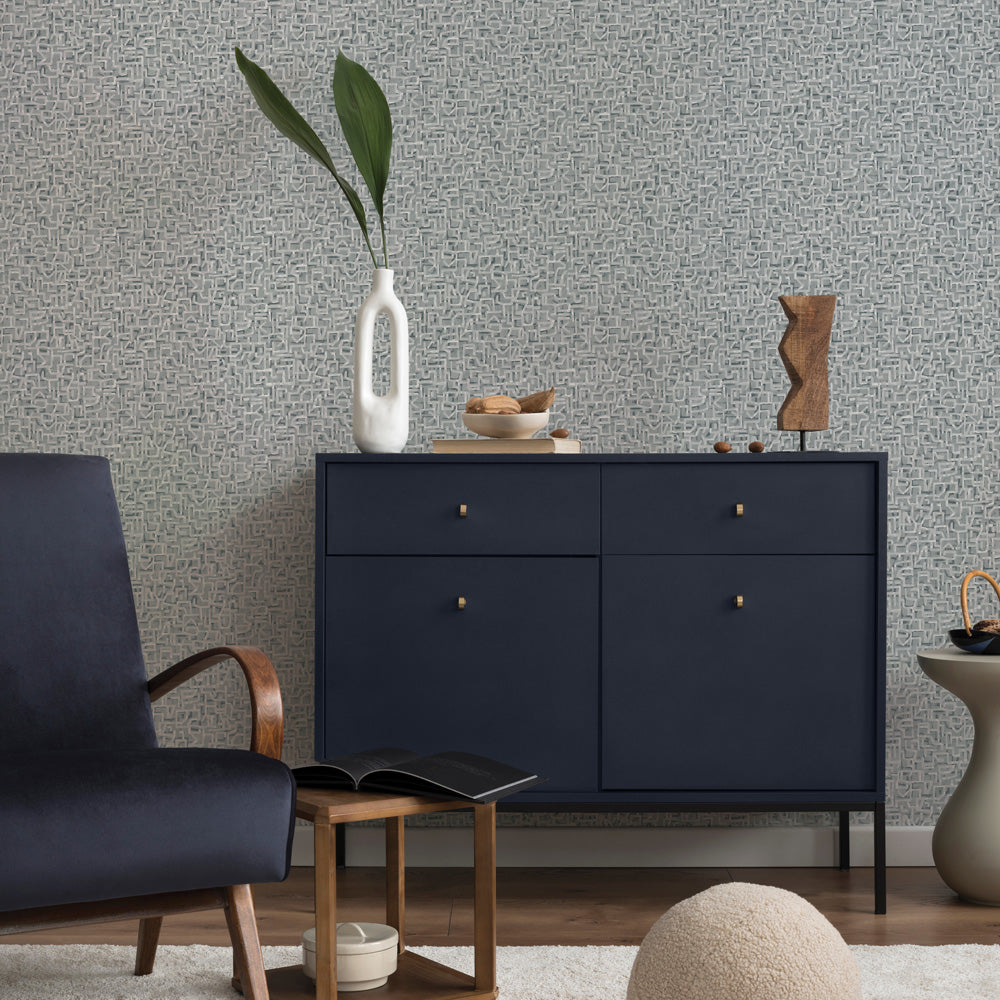 Glyph Geo Non-Pasted Wallpaper - A black dresser and black chair in front of Glyph Geo Unpasted Wallpaper in graphite geo | Tempaper#color_graphite-geo