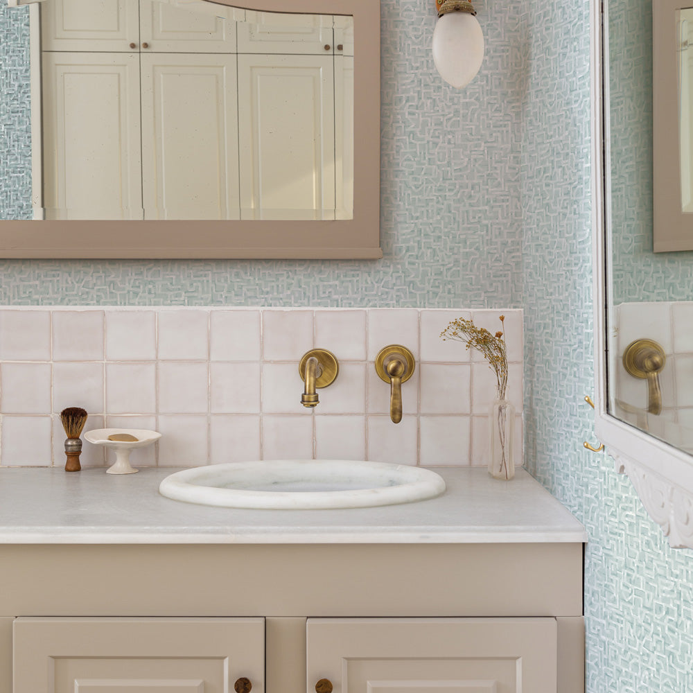 Glyph Geo Non-Pasted Wallpaper - A bathroom with a mirror and a tan vanity featuring Glyph Geo Unpasted Wallpaper in mint geo | Tempaper#color_mint-geo