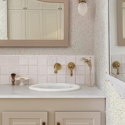 Glyph Geo Non-Pasted Wallpaper - A bathroom with a mirror and a tan vanity featuring Glyph Geo Unpasted Wallpaper in fawn geo | Tempaper#color_fawn-geo
