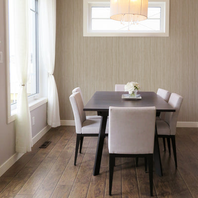 Faux Grasscloth Removable Wallpaper - A brown table and white chairs in a dining room featuring Faux Grasscloth Peel And Stick Wallpaper in textured sand | Tempaper#color_textured-sand