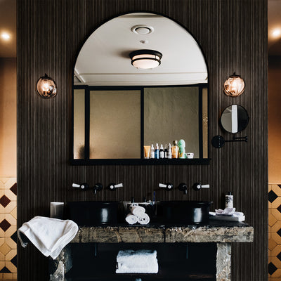 Faux Grasscloth Removable Wallpaper - A vanity with black sinks in a bathroom featuring Faux Grasscloth Peel And Stick Wallpaper in textured black linen | Tempaper#color_textured-black-linen