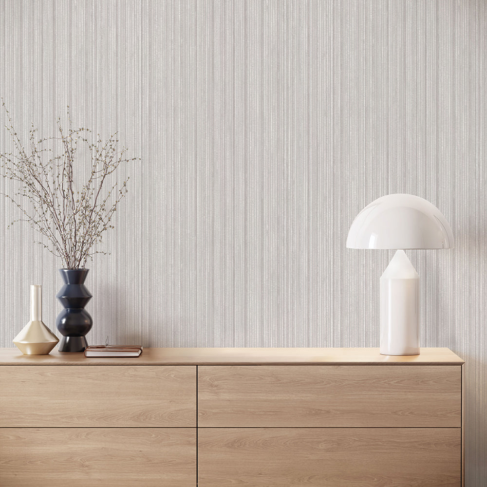 Faux Grasscloth Removable Wallpaper - A wood sideboard with a white lamp in a room featuring Faux Grasscloth Peel And Stick Wallpaper in textured sterling silver | Tempaper#color_textured-sterling-silver