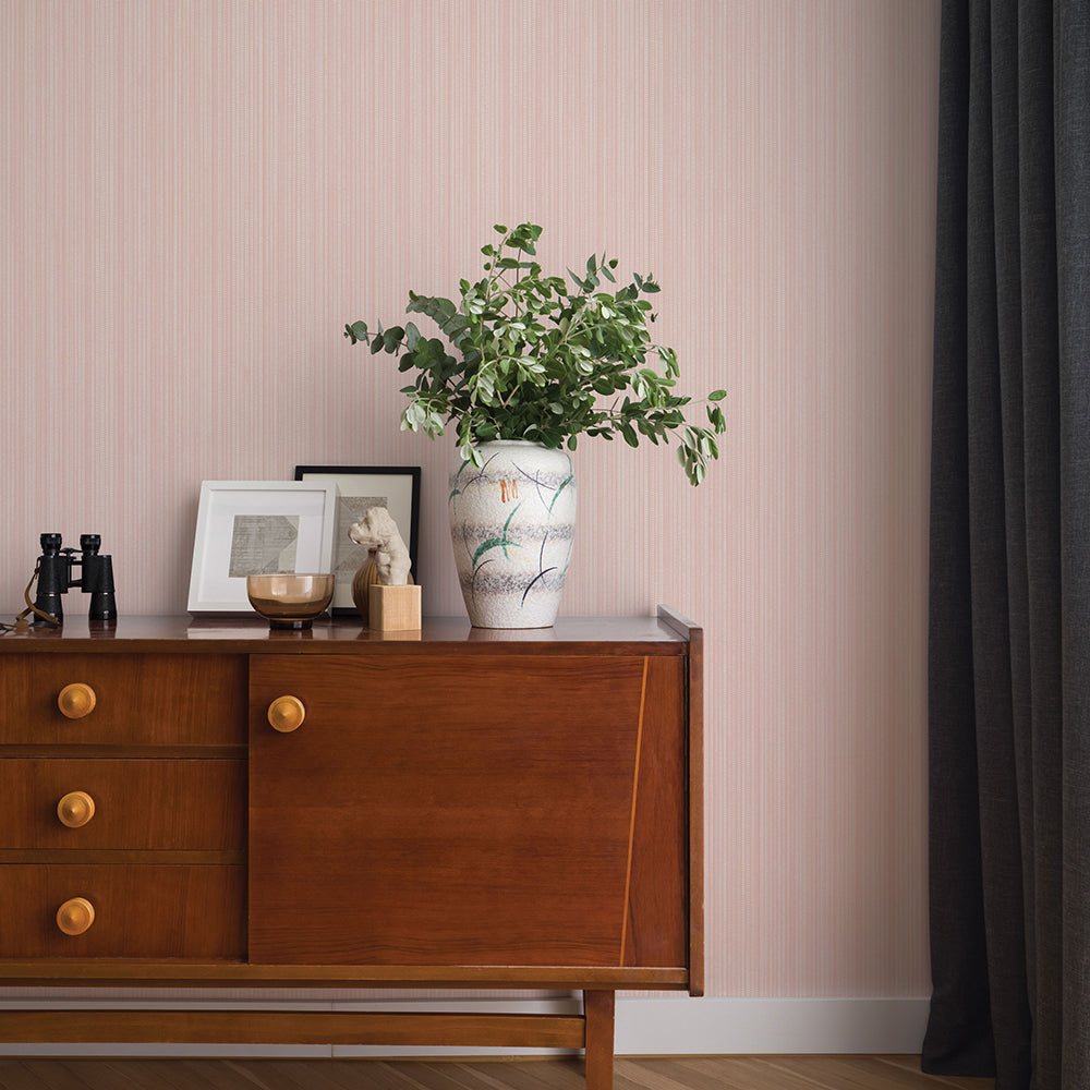 Faux Grasscloth Removable Wallpaper - A wood sideboard with a vase and plant in a room featuring Faux Grasscloth Peel And Stick Wallpaper in textured blush | Tempaper#color_textured-blush