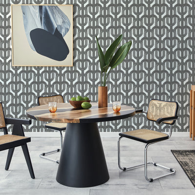 Dark grey lattice wallpaper print is on the wall behind a modern kitchen table #color_ink