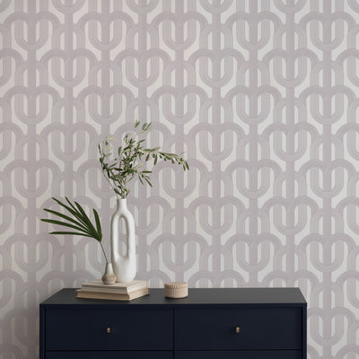 Lattice wallpaper in a grey colorway is paired with a dark navy dresser in a bedroom#color_muted-mauve