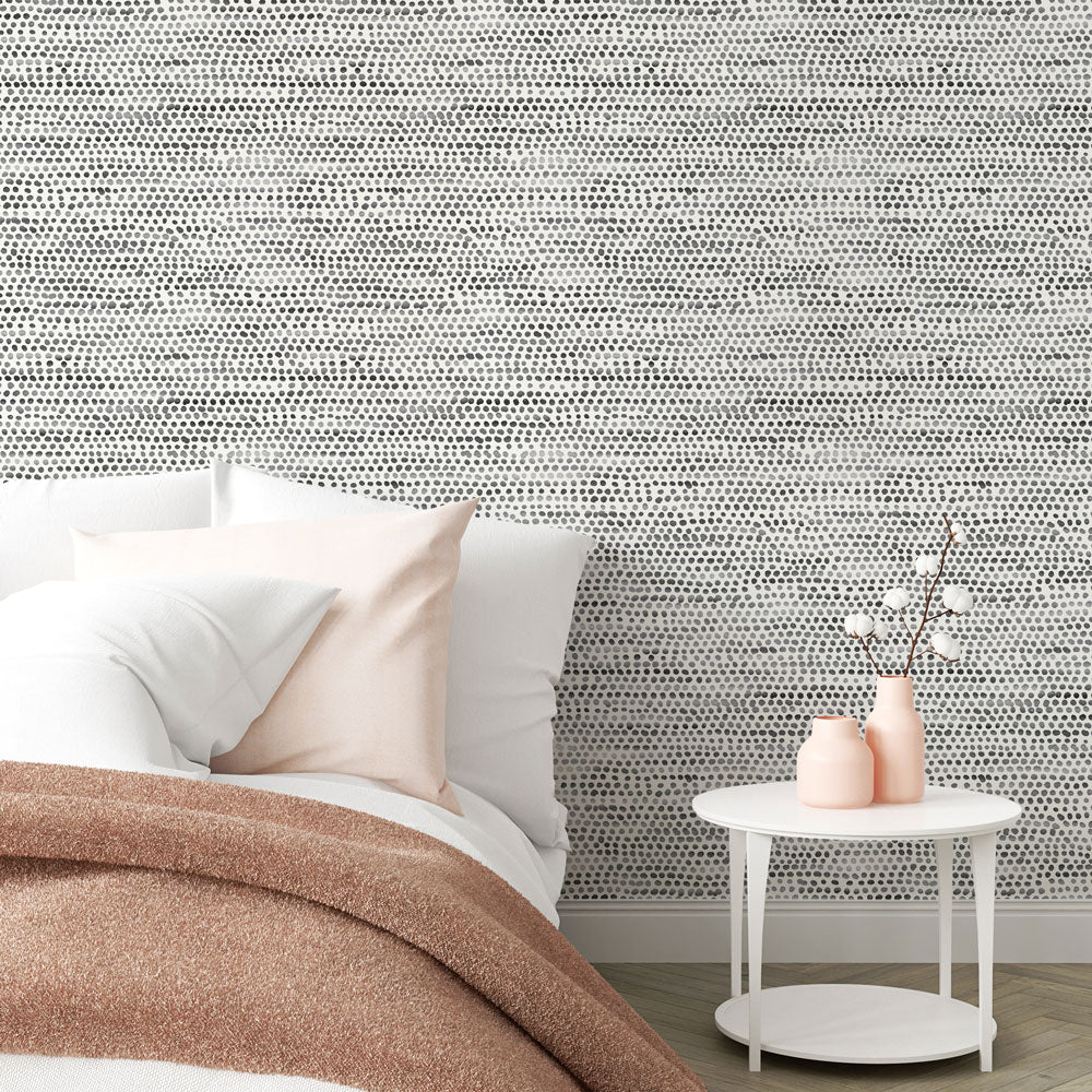 Moire Dots Removable Wallpaper - A bedroom with a bed and white nightstand featuring Tempaper's Moire Dots Peel And Stick Wallpaper in black and white dots | Tempaper#color_black-and-white-dots
