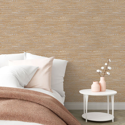 Moire Dots Removable Wallpaper - A bed and a white nightstand in a bedroom featuring Tempaper's Moire Dots Peel And Stick Wallpaper in toasted turmeric dots | Tempaper#color_toasted-turmeric-dots