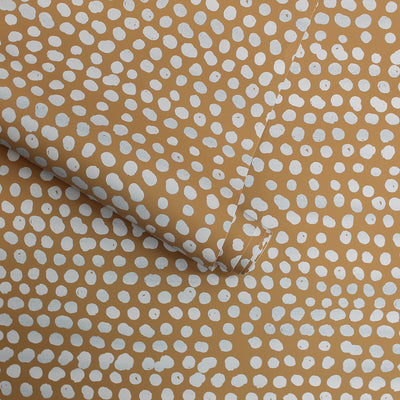 Moire Dots Removable Wallpaper - A roll of Tempaper's Moire Dots Peel And Stick Wallpaper in toasted turmeric dots | Tempaper#color_toasted-turmeric-dots