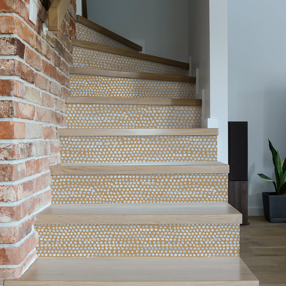 Moire Dots Removable Wallpaper - A brick wall with stairs featuring Tempaper's Moire Dots Peel And Stick Wallpaper in toasted turmeric dots | Tempaper#color_toasted-turmeric-dots